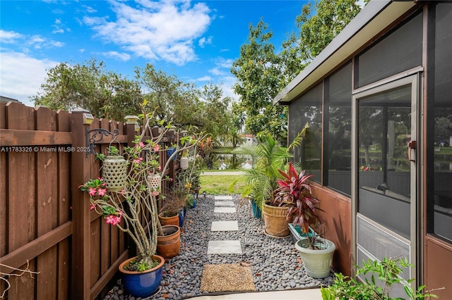 view of yard featuring a sunroom and fence
