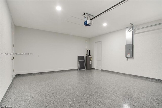 3308 SW 17th St, Lehigh Acres, FL 33971 - garage featuring baseboards, electric panel, recessed lighting, water heater, and a garage door opener