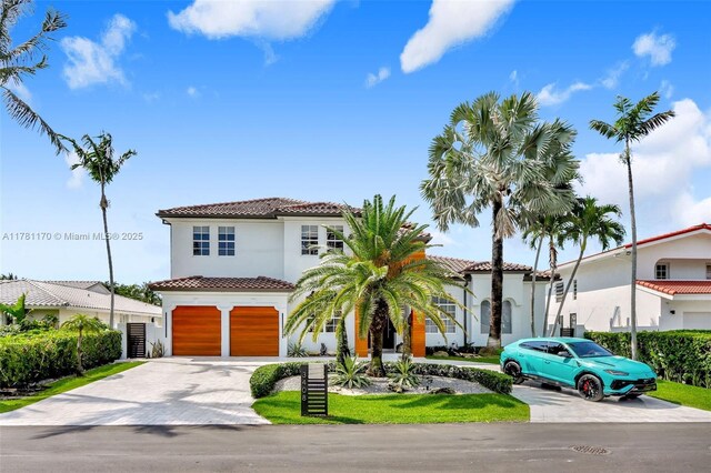 3408 NE 169th St, North Miami Beach, FL 33160 - mediterranean / spanish-style home featuring a garage, driveway, a tiled roof, and stucco siding