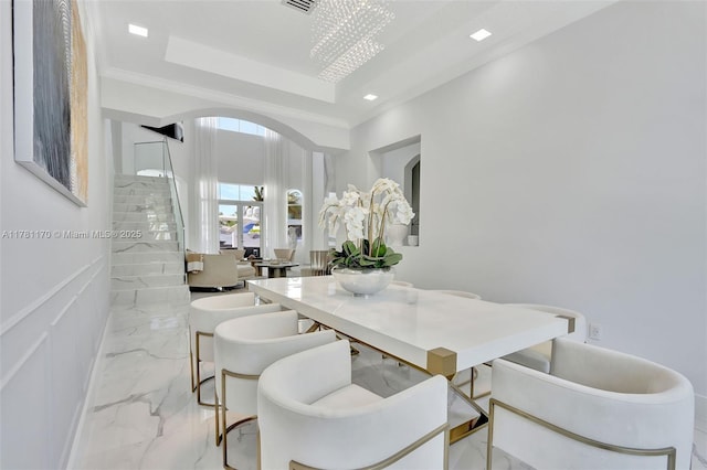 3408 NE 169th St, North Miami Beach, FL 33160 - dining area featuring a raised ceiling, arched walkways, marble finish floor, and stairs