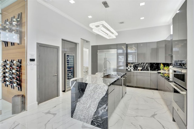 3408 NE 169th St, North Miami Beach, FL 33160 - kitchen featuring modern cabinets, a sink, ornamental molding, stainless steel appliances, and gray cabinets
