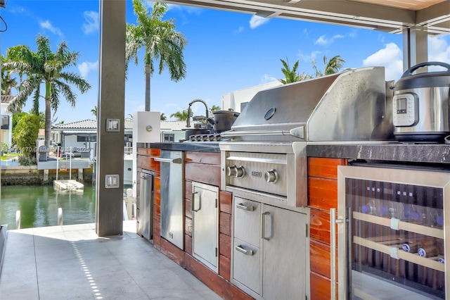 3408 NE 169th St, North Miami Beach, FL 33160 - view of patio featuring a water view, beverage cooler, and an outdoor kitchen