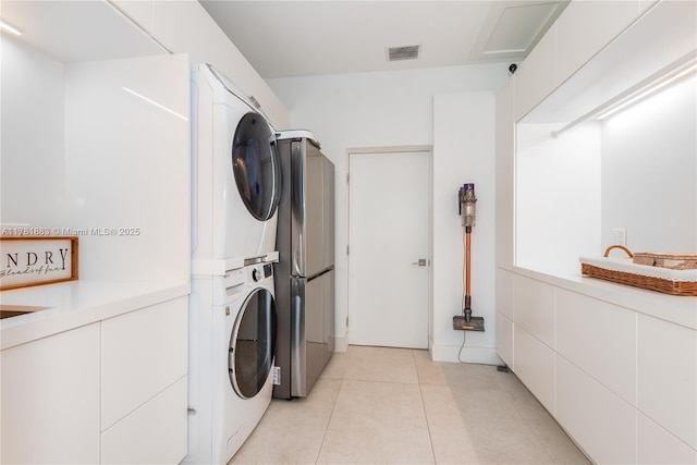 6295 SW 126th St, Pinecrest, FL 33156 - washroom with estacked washer and dryer and light tile patterned floors