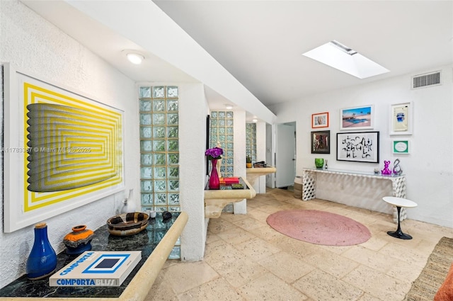 3200 Morris Ln, Miami, FL 33133 - full bathroom with a skylight, stone tile floors, vanity, and visible vents