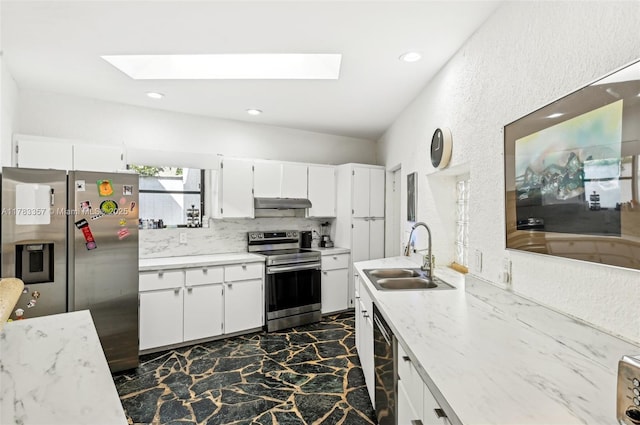 3200 Morris Ln, Miami, FL 33133 - kitchen featuring a skylight, under cabinet range hood, a sink, and stainless steel appliances