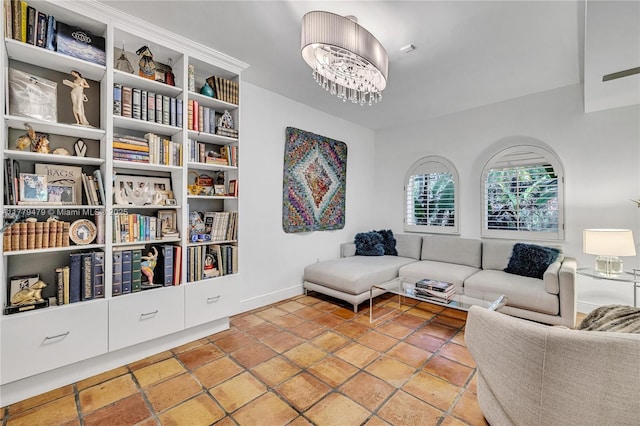 sitting room featuring tile patterned floors, baseboards, and a notable chandelier