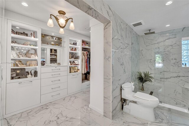 bathroom featuring visible vents, marble finish floor, an inviting chandelier, and a marble finish shower