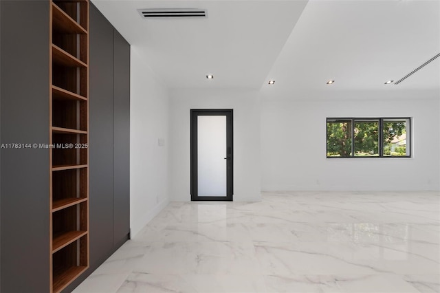 empty room featuring visible vents, marble finish floor, and recessed lighting