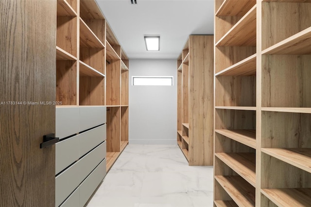 spacious closet with marble finish floor