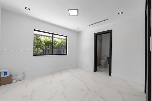 unfurnished bedroom with baseboards, marble finish floor, connected bathroom, and visible vents