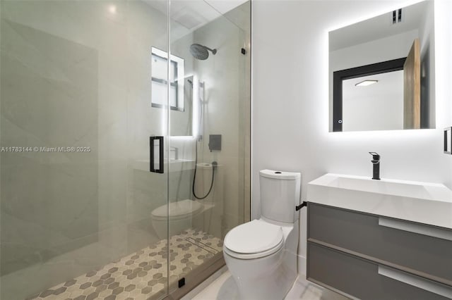 bathroom featuring a stall shower, vanity, toilet, and visible vents