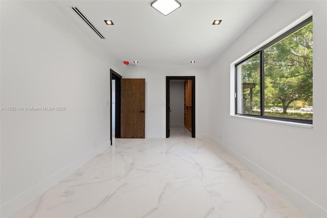 unfurnished bedroom with baseboards, marble finish floor, and visible vents