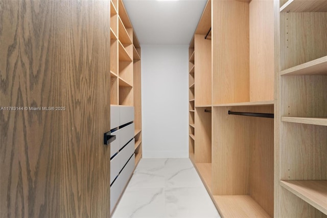 spacious closet with marble finish floor