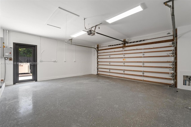 garage featuring electric panel and a garage door opener