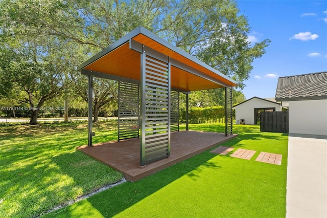 exterior space with a yard, a deck, and fence