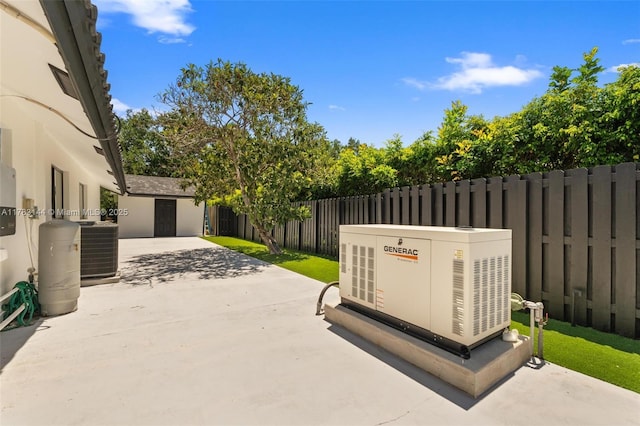 view of patio with central air condition unit and fence