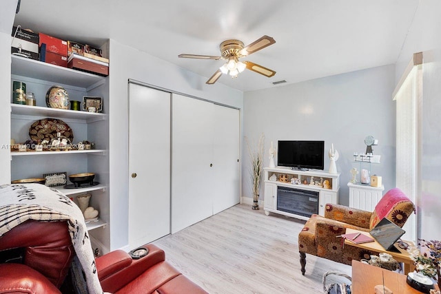 18201 SW 87th Ave, Palmetto Bay, FL 33157 - living room featuring a ceiling fan, wood finished floors, and a glass covered fireplace