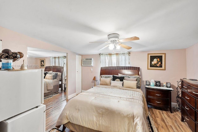 18201 SW 87th Ave, Palmetto Bay, FL 33157 - bedroom featuring freestanding refrigerator, light wood-type flooring, an AC wall unit, a ceiling fan, and vaulted ceiling