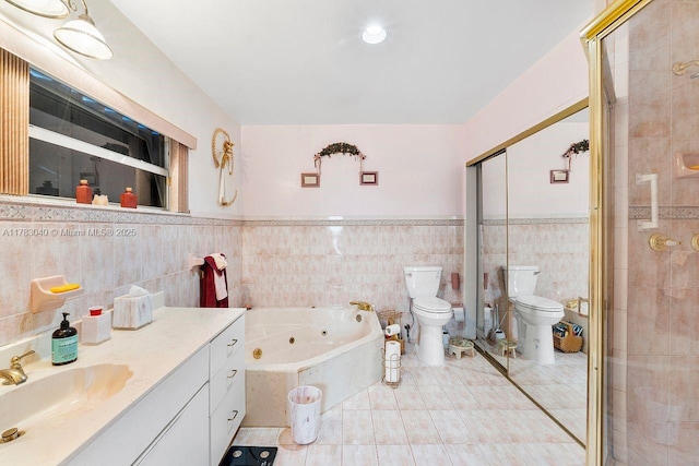 18201 SW 87th Ave, Palmetto Bay, FL 33157 - full bath with toilet, a jetted tub, vanity, tile walls, and a wainscoted wall