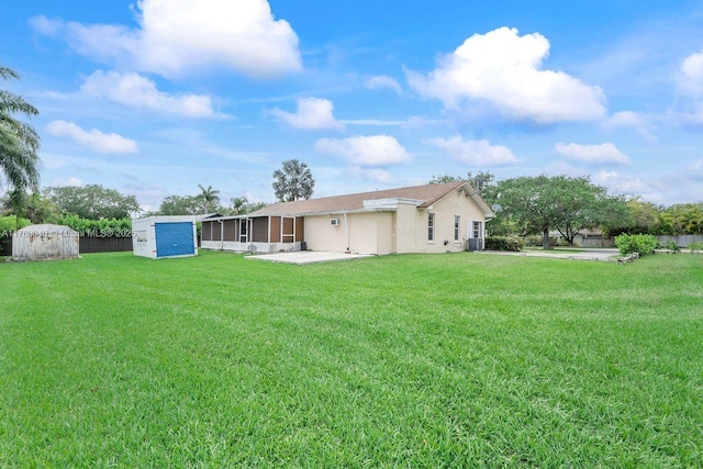 18201 SW 87th Ave, Palmetto Bay, FL 33157 - back of property with a patio area, a lawn, and stucco siding