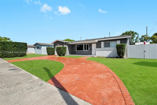 5117 Washington St, Hollywood, FL 33021 - single story home with stucco siding, fence, a front lawn, and a gate