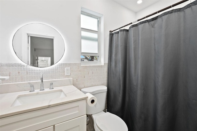 5117 Washington St, Hollywood, FL 33021 - bathroom featuring toilet, vanity, wainscoting, and tile walls
