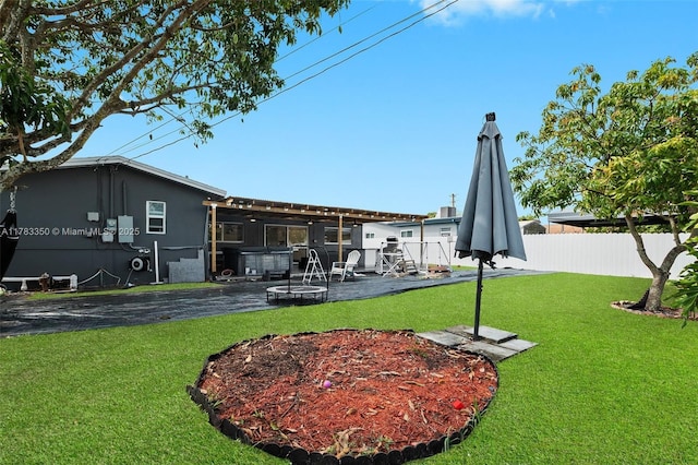5117 Washington St, Hollywood, FL 33021 - back of house featuring a patio area, fence, and a lawn