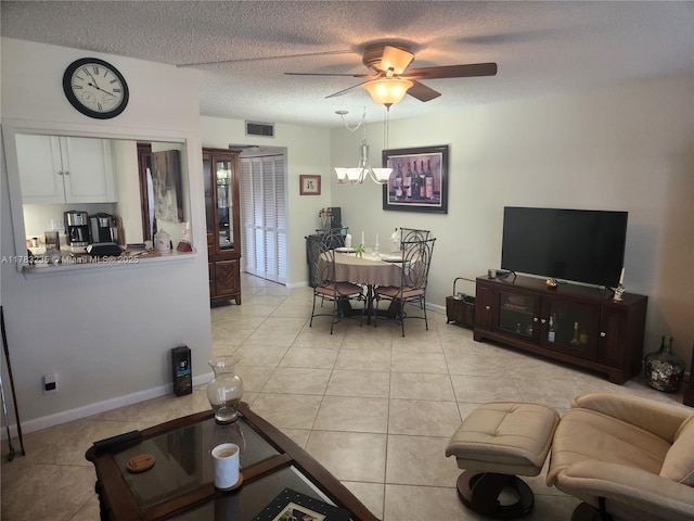 2114 E Cambridge E Unit 2114, Deerfield Beach, FL 33442 - living room featuring light tile patterned floors, visible vents, ceiling fan with notable chandelier, and a textured ceiling