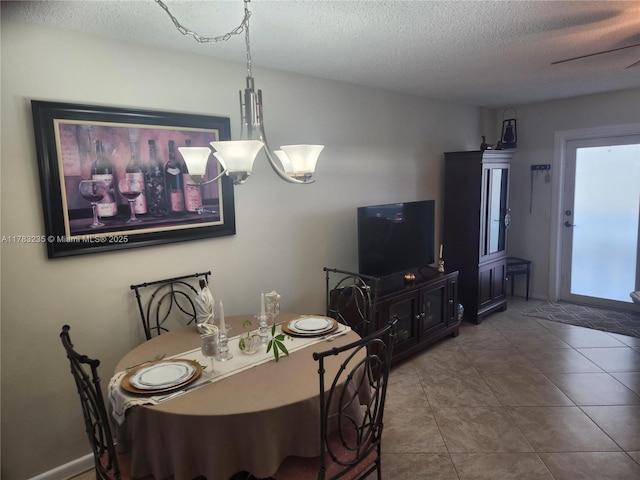 2114 E Cambridge E Unit 2114, Deerfield Beach, FL 33442 - dining area with a textured ceiling, baseboards, and tile patterned flooring
