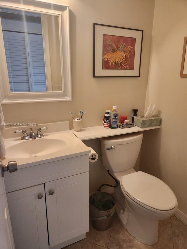 2114 E Cambridge E Unit 2114, Deerfield Beach, FL 33442 - bathroom featuring toilet, tile patterned floors, and vanity