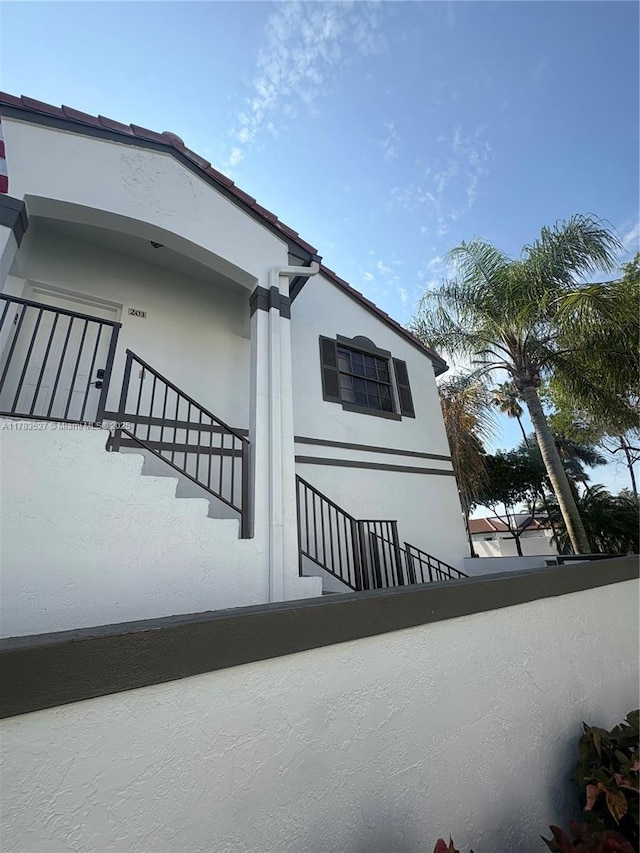 502 SW 158th Ter Unit 203, Pembroke Pines, FL 33027 - view of home's exterior featuring stucco siding and stairway