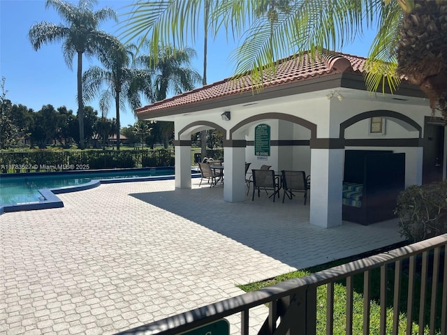 community pool featuring a patio, a gazebo, and fence