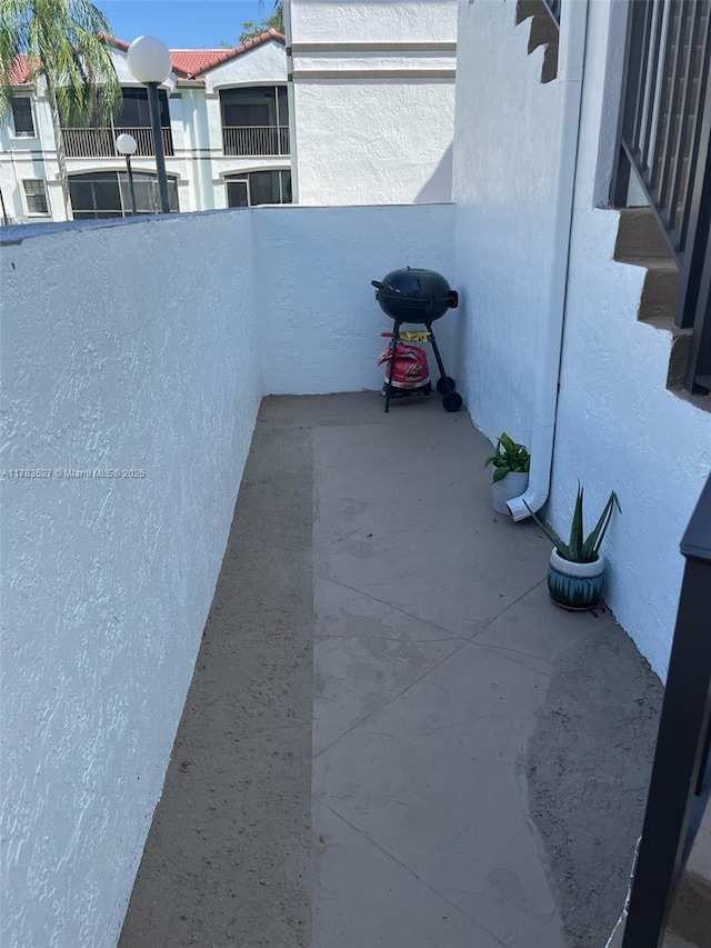 view of patio / terrace featuring a grill and a balcony