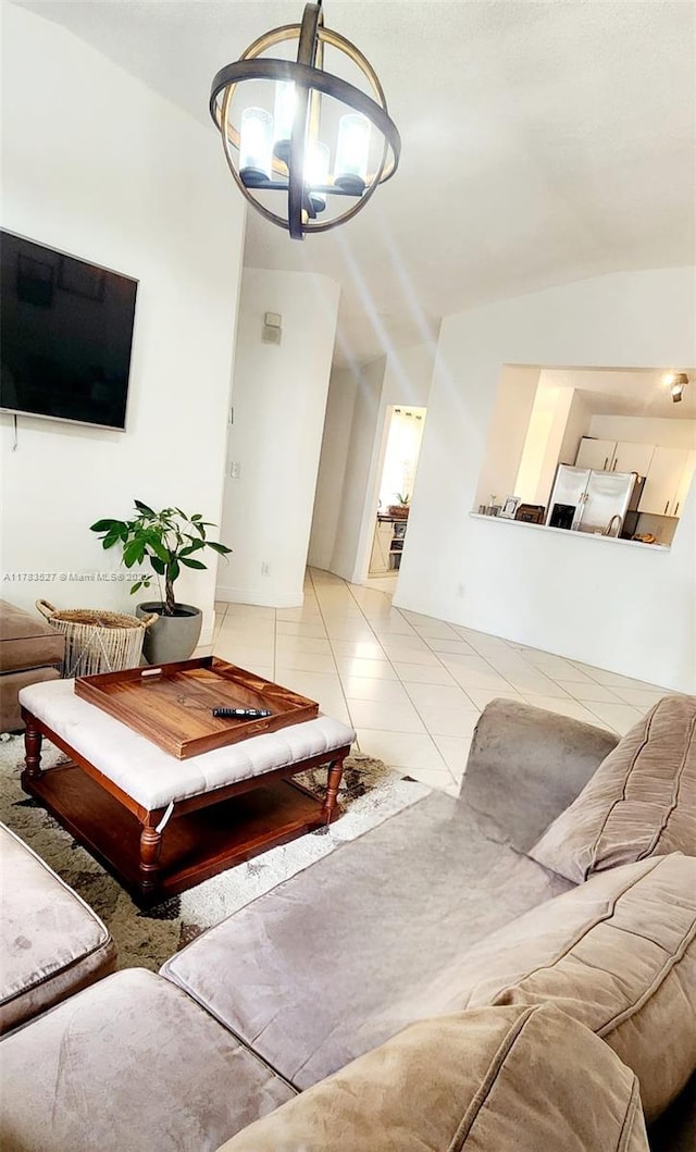 tiled living area with lofted ceiling and a notable chandelier