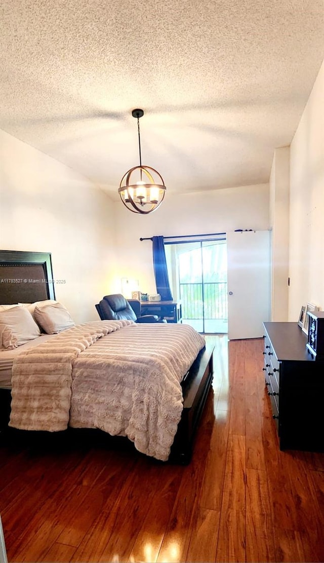 502 SW 158th Ter Unit 203, Pembroke Pines, FL 33027 - bedroom featuring hardwood / wood-style floors, a textured ceiling, and a chandelier