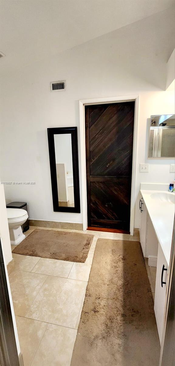502 SW 158th Ter Unit 203, Pembroke Pines, FL 33027 - bathroom featuring vanity, toilet, and tile patterned floors