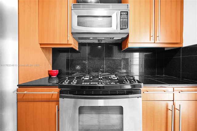 kitchen featuring decorative backsplash, dark countertops, exhaust hood, and stainless steel appliances