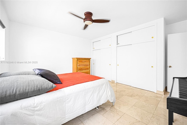 bedroom with two closets and a ceiling fan