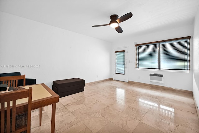 interior space with ceiling fan, heating unit, marble finish floor, and baseboards