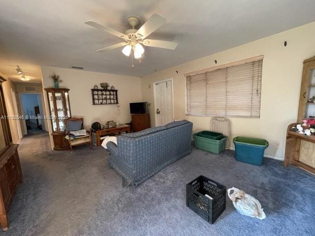 carpeted living area with ceiling fan and visible vents