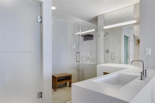 full bathroom with a stall shower, vanity, and tile patterned floors