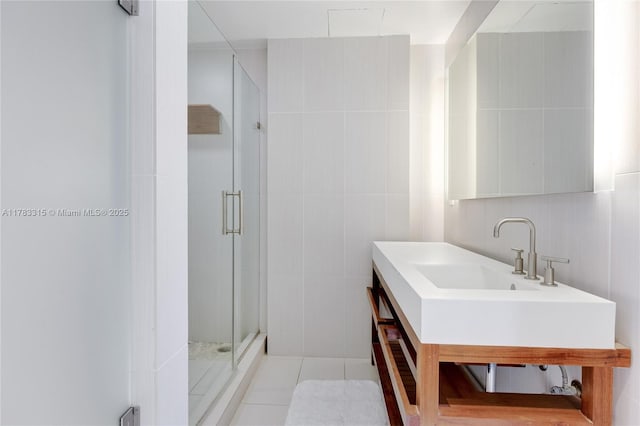bathroom featuring a shower stall, tile patterned floors, vanity, and tile walls