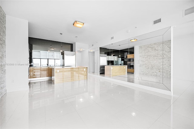 empty room with visible vents and light tile patterned floors