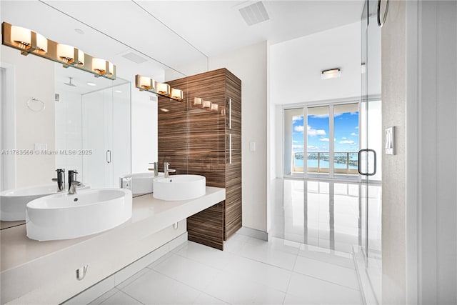 bathroom with a sink, tile patterned flooring, and a stall shower