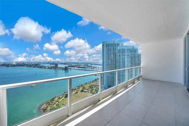 balcony featuring a view of city and a water view