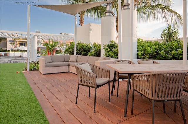 wooden deck with a yard and outdoor dining area