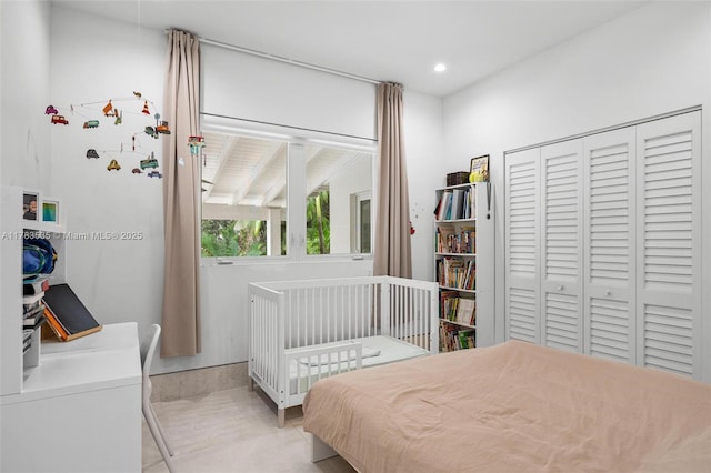 bedroom featuring a closet, light tile patterned floors, and recessed lighting