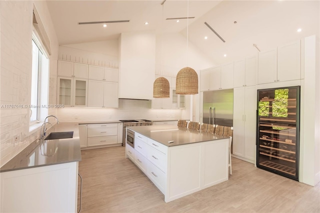 8200 SW 62nd Ave, Miami, FL 33143 - kitchen with white cabinetry, decorative backsplash, a sink, and wine cooler