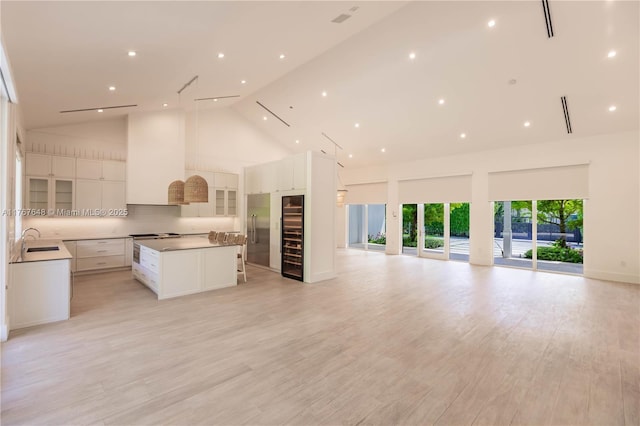 8200 SW 62nd Ave, Miami, FL 33143 - kitchen featuring a sink, beverage cooler, high vaulted ceiling, open floor plan, and a spacious island