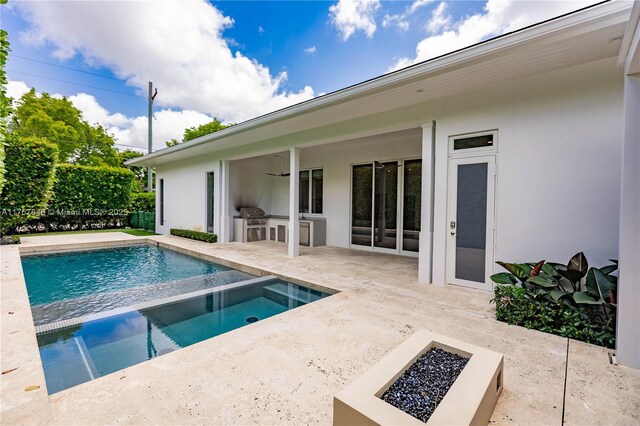 8200 SW 62nd Ave, Miami, FL 33143 - outdoor pool featuring an outdoor fire pit, an outdoor kitchen, ceiling fan, an in ground hot tub, and a patio